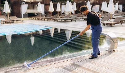 Professional Pool Maintenance Technician Cleaning Swimming Pool