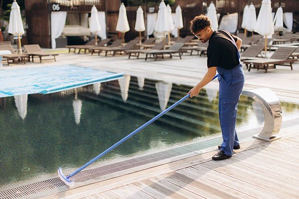 Professional Pool Maintenance Technician Cleaning Swimming Pool